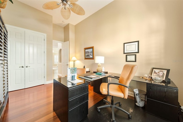 office area featuring ceiling fan, lofted ceiling, and wood-type flooring