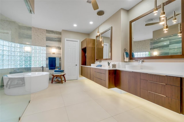 bathroom featuring tile walls, a tub, tile patterned flooring, and vanity