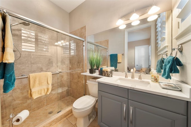 bathroom featuring vanity, an enclosed shower, tile patterned floors, and toilet