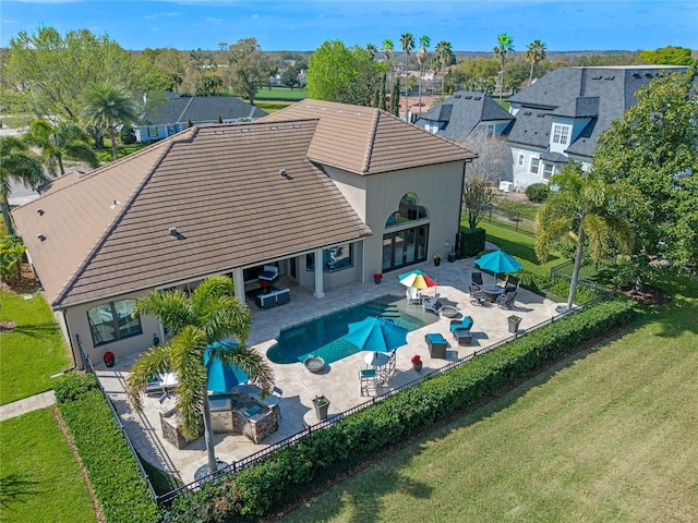 rear view of house featuring a yard, a patio, and outdoor lounge area