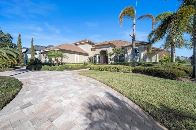 mediterranean / spanish house with a front lawn