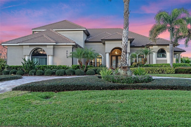 view of front of property featuring french doors and a yard