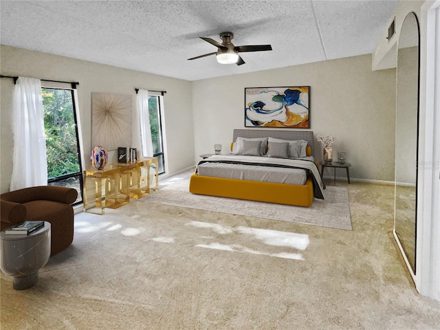 bedroom featuring carpet floors, a textured ceiling, and ceiling fan