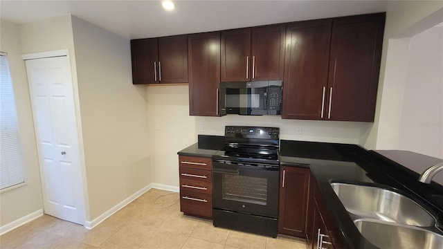 kitchen with black appliances, sink, and light tile flooring