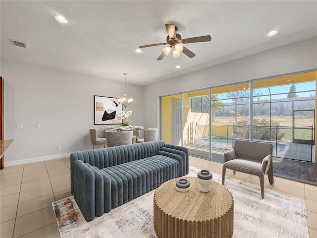 living room with tile patterned floors and ceiling fan with notable chandelier