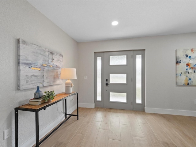 foyer featuring light hardwood / wood-style floors and a wealth of natural light