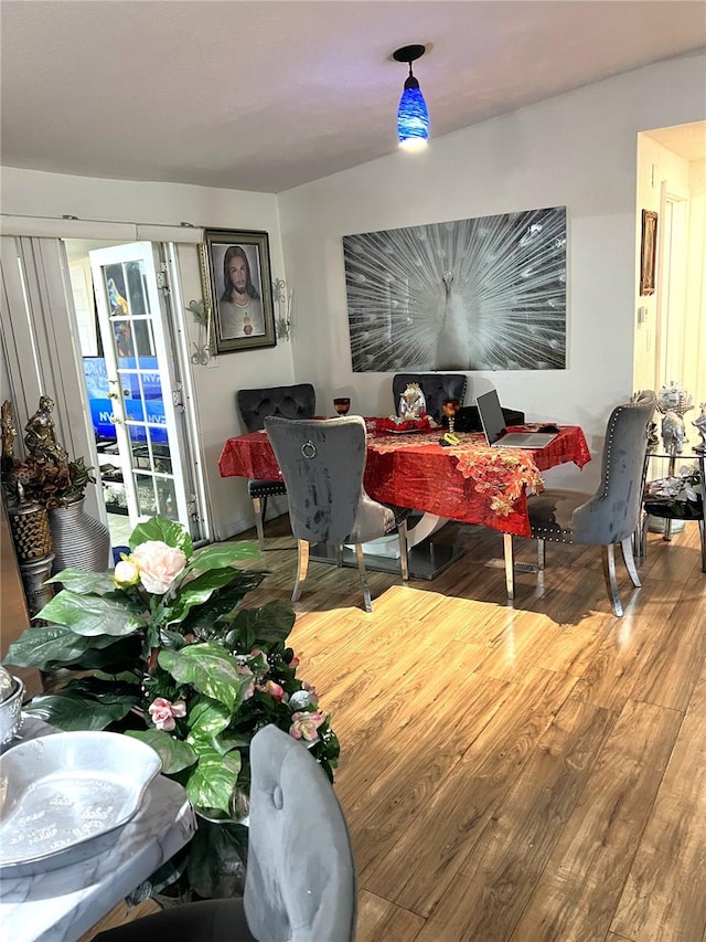 dining area with hardwood / wood-style floors and french doors