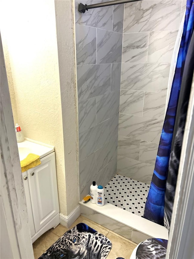 bathroom featuring tile floors, vanity, and a shower with curtain