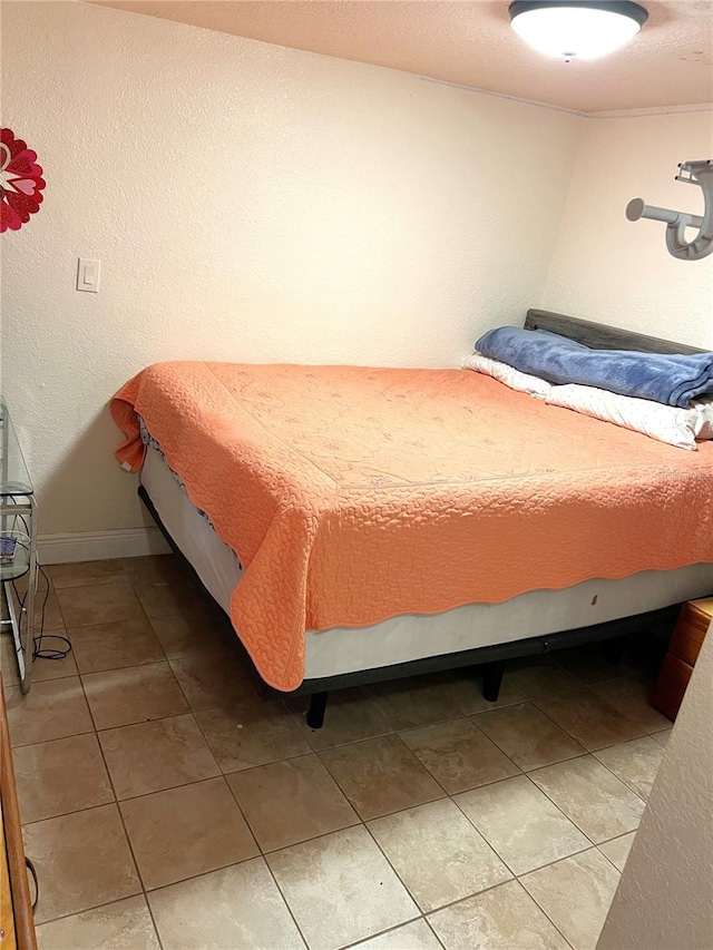 bedroom with light tile flooring