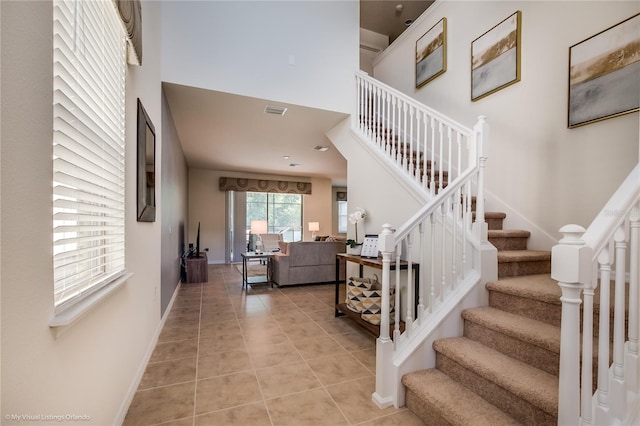 stairs featuring light tile flooring