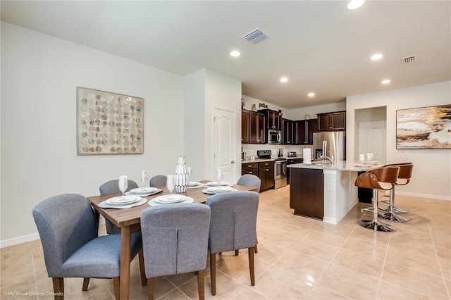 dining area with light tile flooring and sink