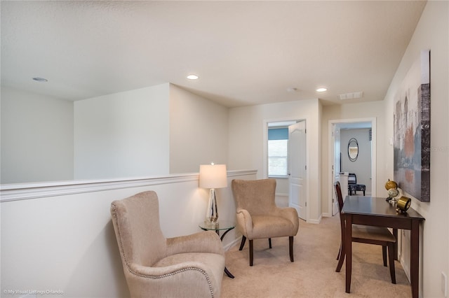 living area featuring light colored carpet