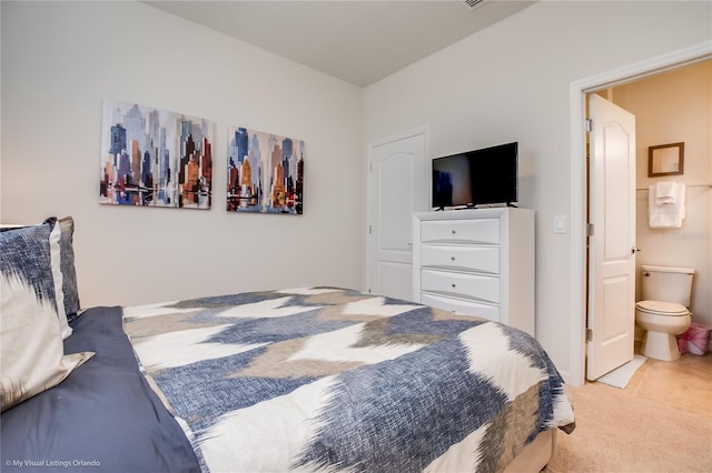 carpeted bedroom with connected bathroom