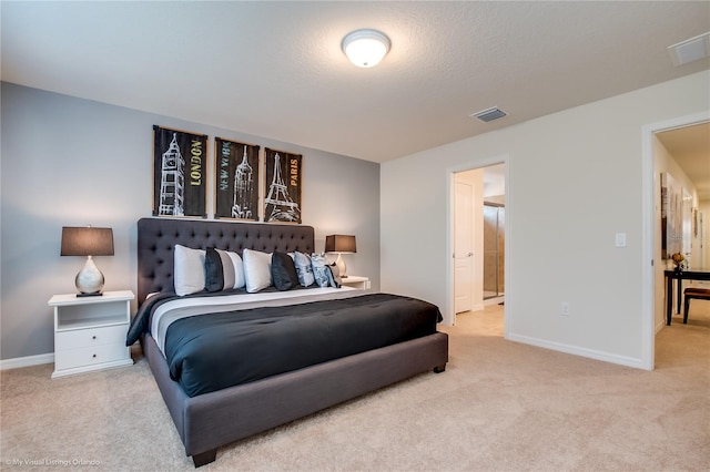 carpeted bedroom with ensuite bathroom