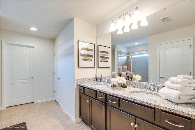 bathroom with double vanity and tile floors