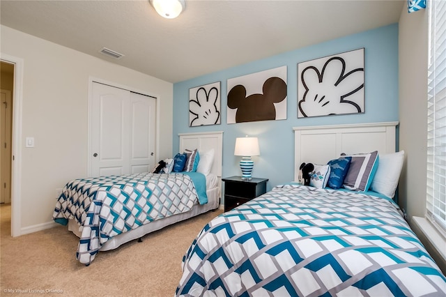 bedroom featuring a closet and light carpet