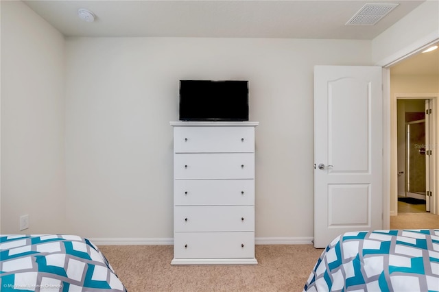 bedroom with light colored carpet