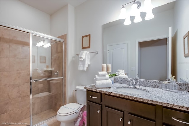 bathroom with walk in shower, toilet, a notable chandelier, and large vanity