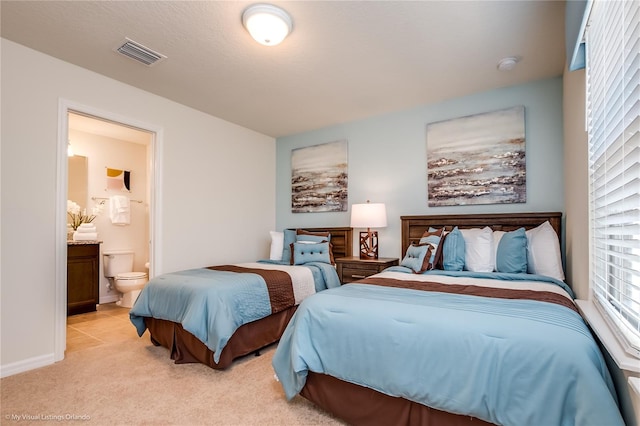 carpeted bedroom with ensuite bathroom