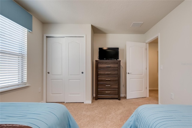 carpeted bedroom with a closet