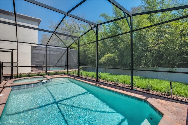 view of pool featuring an in ground hot tub and glass enclosure