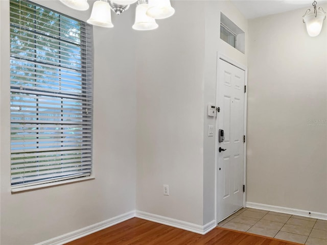 entrance foyer with hardwood / wood-style floors and a chandelier