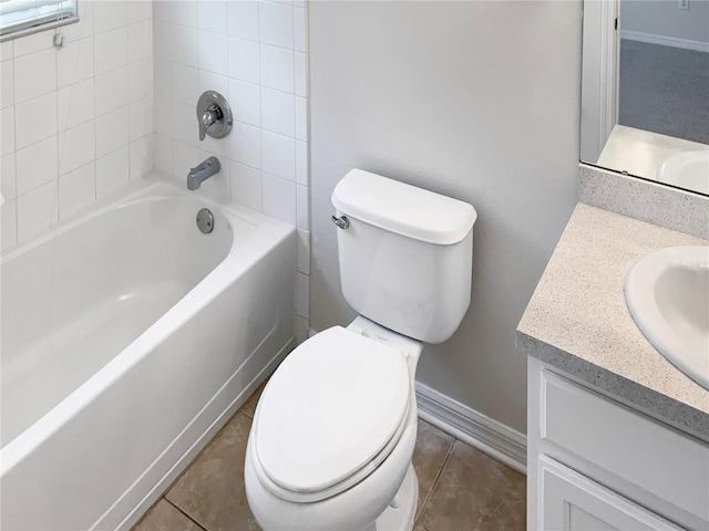 full bathroom featuring tiled shower / bath, vanity, and toilet