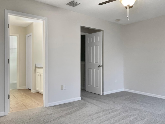 carpeted spare room with ceiling fan