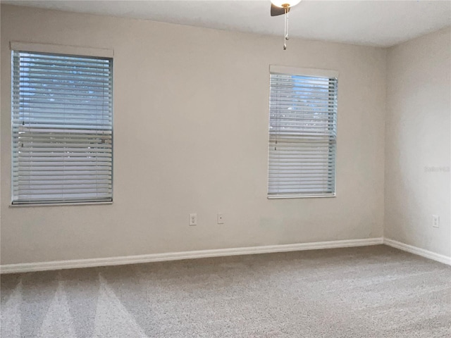 empty room featuring carpet flooring and ceiling fan