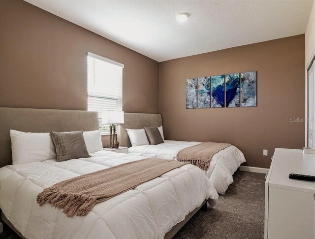 bedroom featuring dark colored carpet