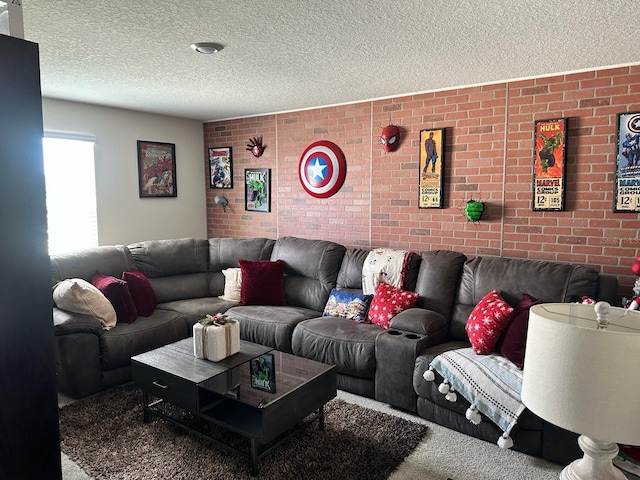 carpeted living room featuring a textured ceiling and brick wall