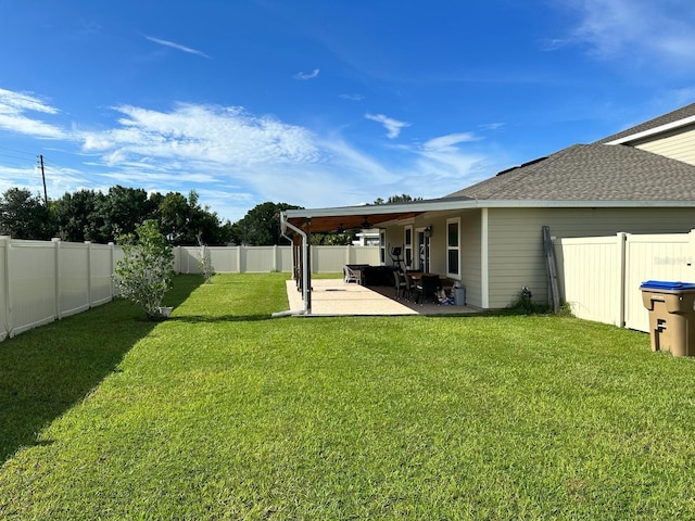 view of yard featuring a patio area and ceiling fan