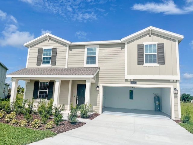 view of front of home featuring a garage and electric water heater