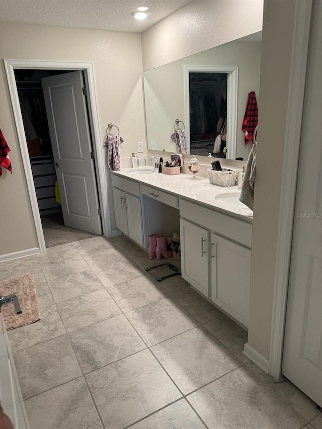 bathroom with a textured ceiling and vanity