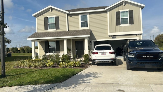 view of front of property featuring a front yard and a garage