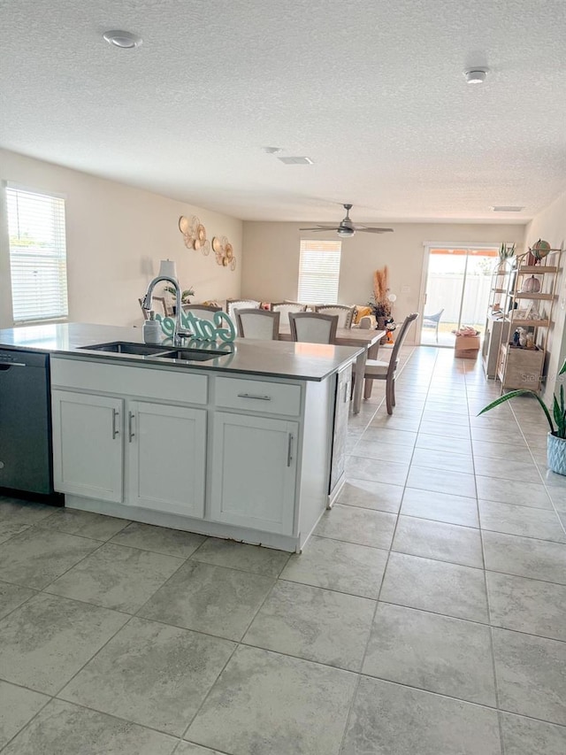 kitchen featuring white cabinets, dishwasher, a wealth of natural light, and sink