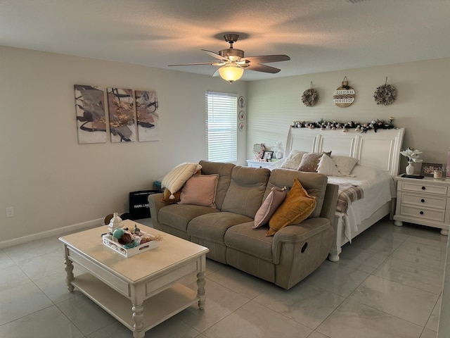 tiled bedroom featuring ceiling fan and a textured ceiling