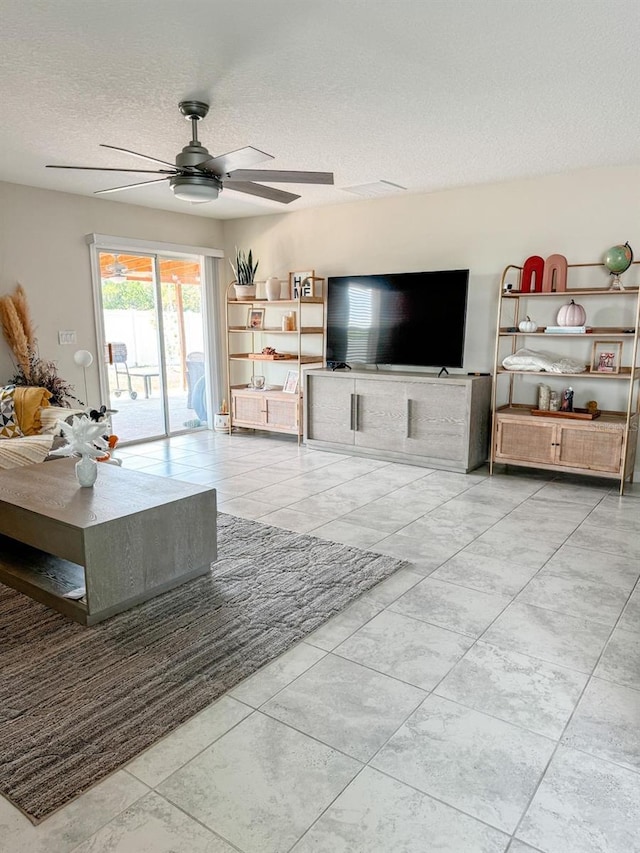 living room featuring light tile patterned floors and a textured ceiling