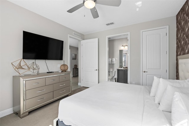 carpeted bedroom with ceiling fan and ensuite bathroom