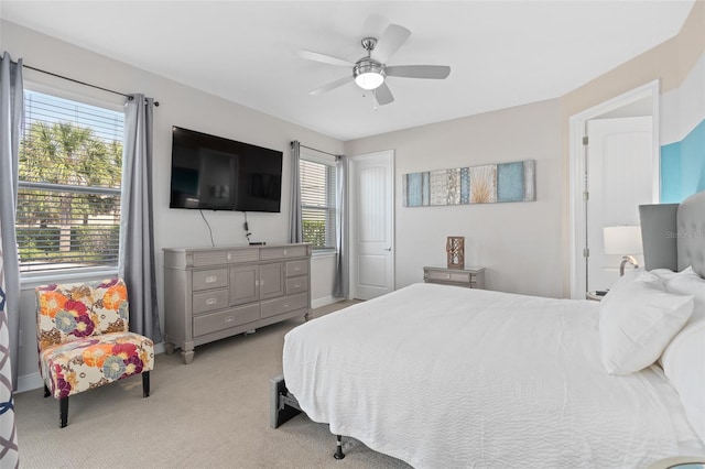 bedroom featuring light carpet and ceiling fan