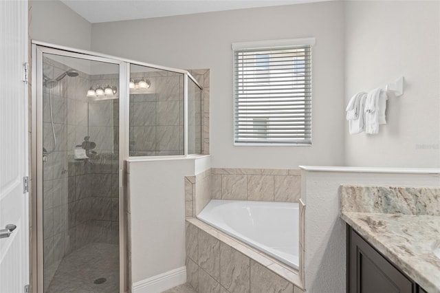 bathroom with independent shower and bath and vanity