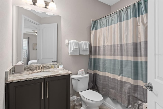 bathroom featuring vanity, ceiling fan, and toilet