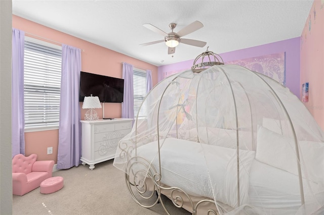 bedroom featuring light colored carpet and ceiling fan