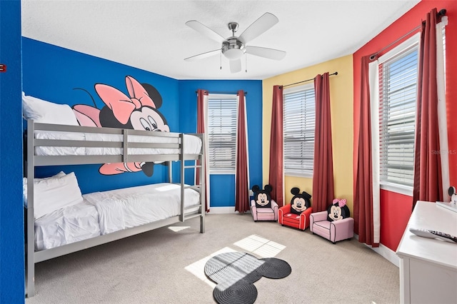 bedroom with light carpet and ceiling fan