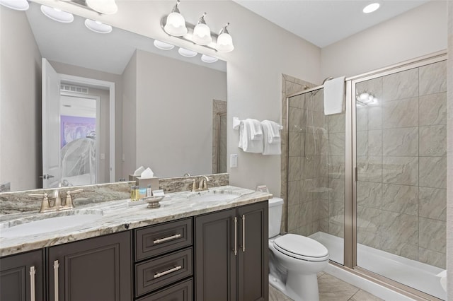 bathroom with an enclosed shower, tile floors, dual sinks, toilet, and oversized vanity