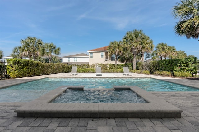 view of pool featuring an in ground hot tub and a patio