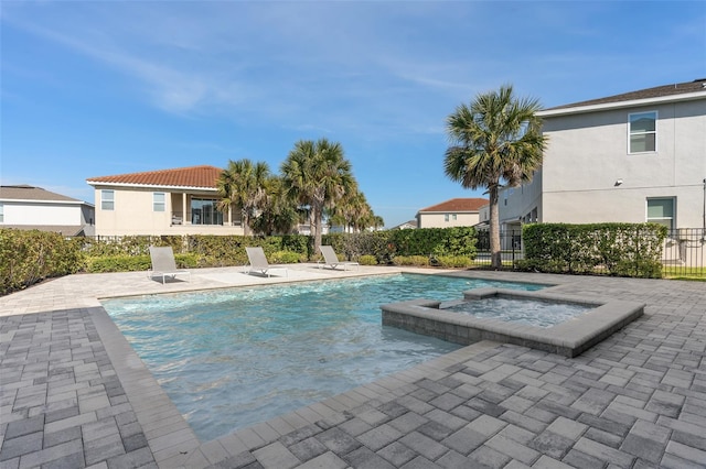 view of pool with an in ground hot tub and a patio