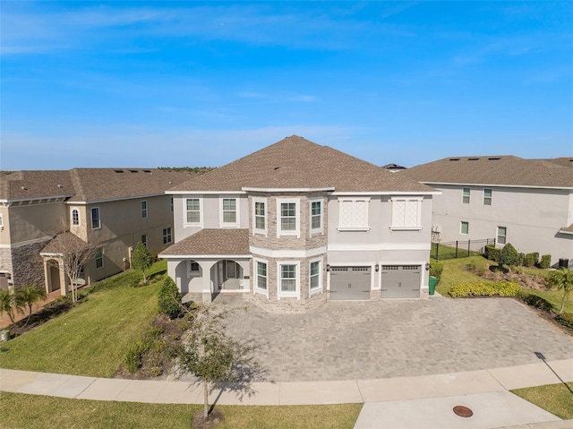 view of front of property with a front lawn and a garage