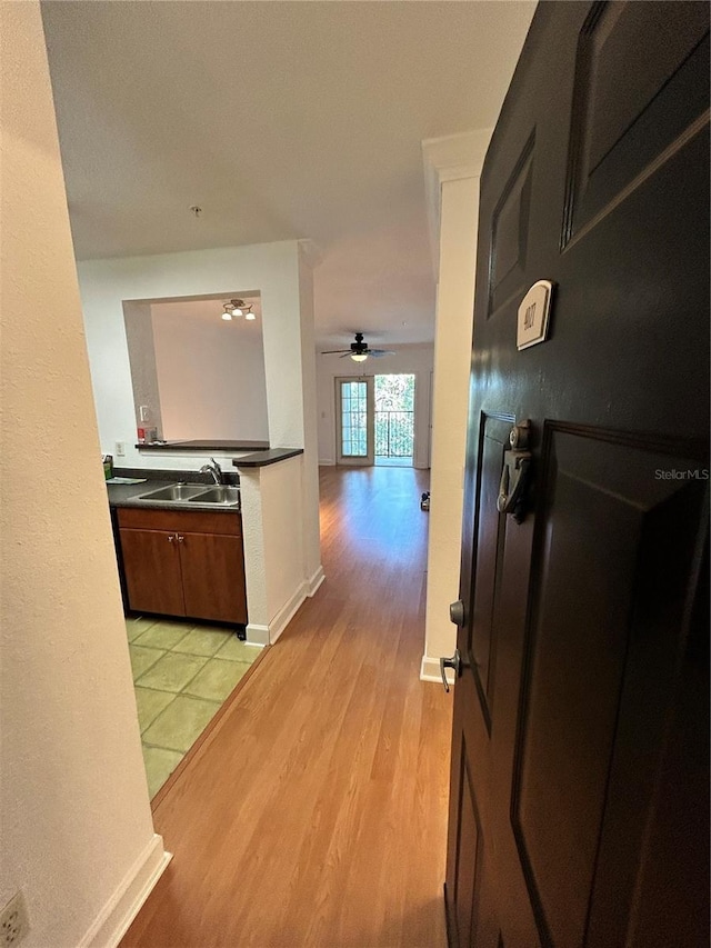 hall featuring sink and light tile floors