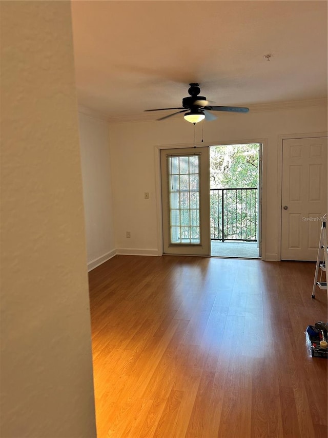 empty room with crown molding, light hardwood / wood-style floors, and ceiling fan